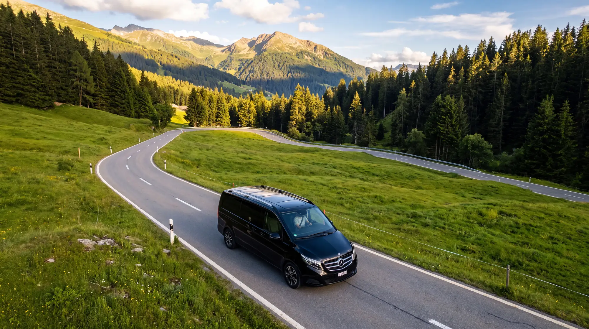 Mercedes taxi van on a lush green mountain road in Crans-Montana in summer